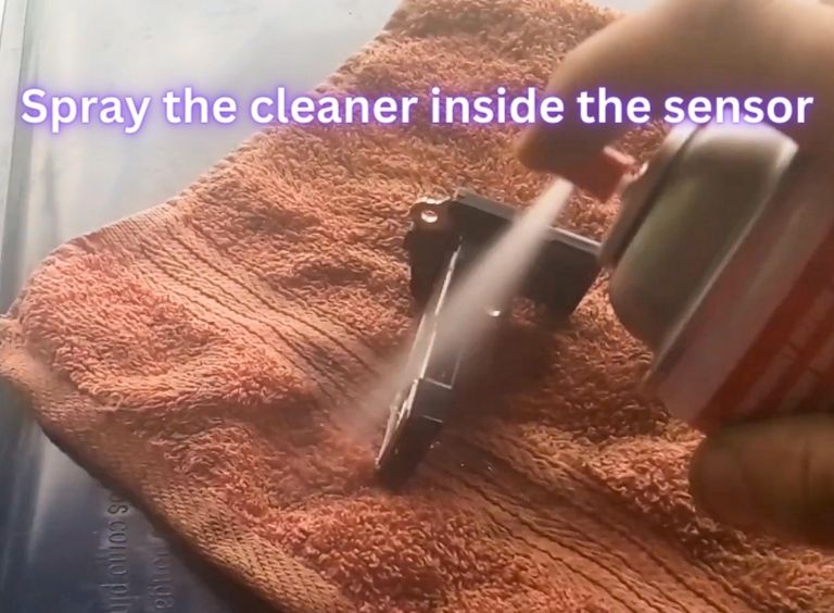 Spray the cleaner inside the sensor